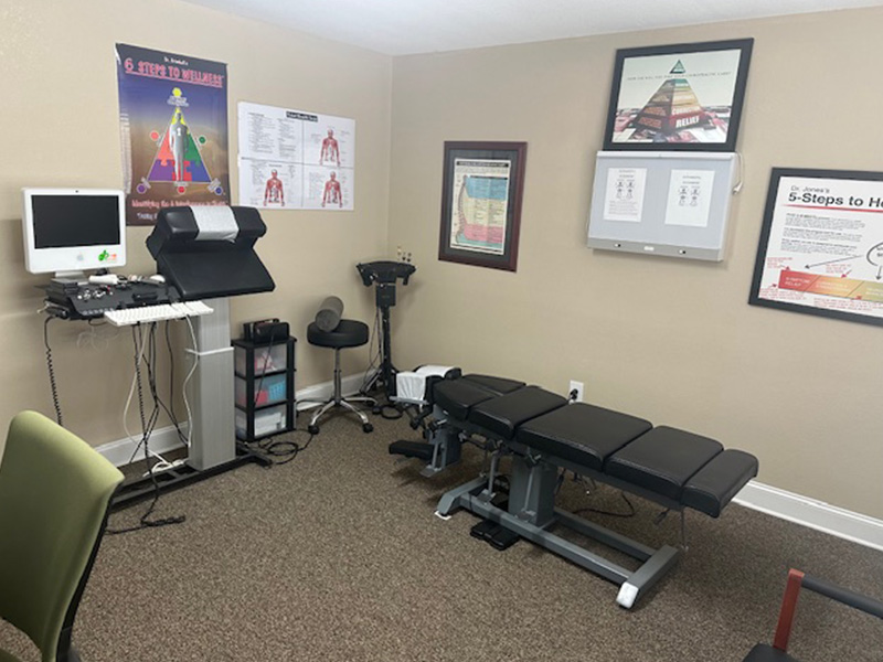Patient room with chiropractic table and posters